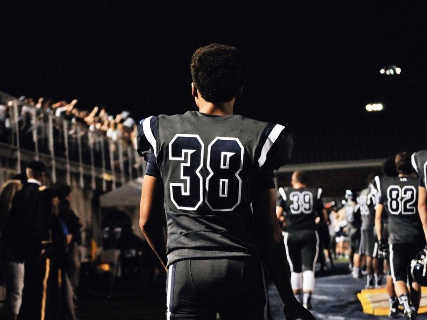 football players leaving field